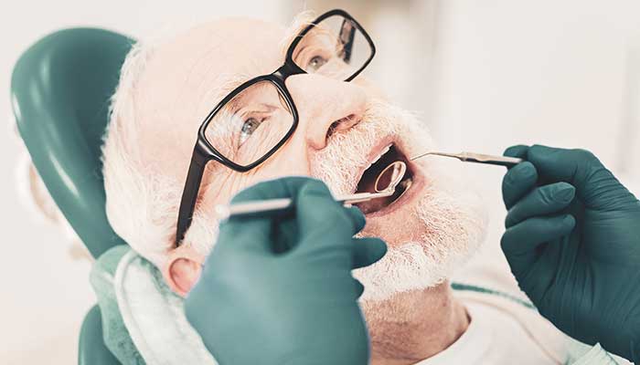 A dentist working on a patients teeth